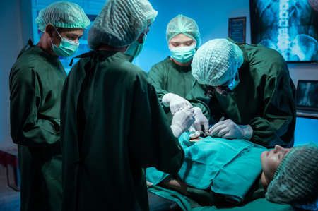 Surgeons team working with Monitoring of patient in surgicalの写真素材