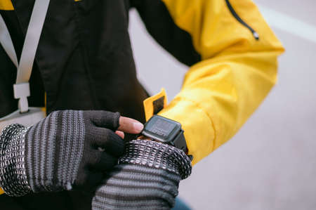Close-up view The hand of the courier is looking at the clock,bike delivery manの写真素材