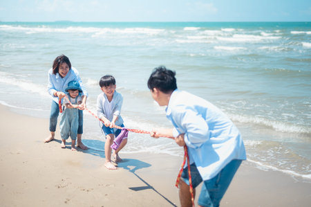 Asian families play sports on vacation Parents and children are together on vacation.