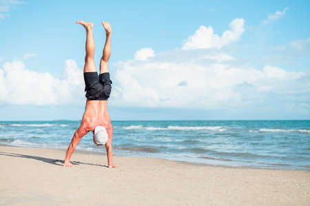 Men doing sport on the beachの写真素材