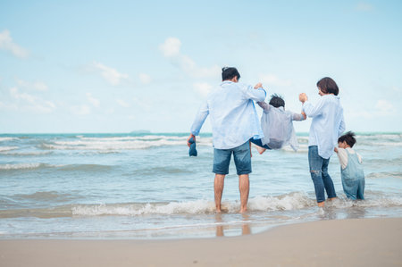Asian families play sports on vacation Parents and children are together on vacation.の写真素材