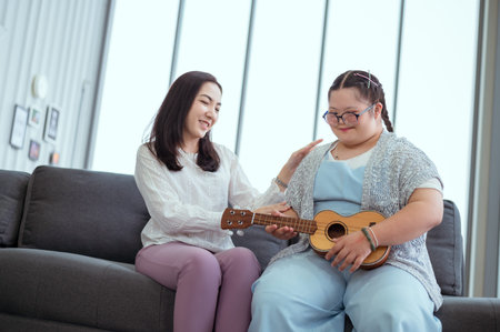 Down syndrome girl plays the guitar with her mom at her holiday home.