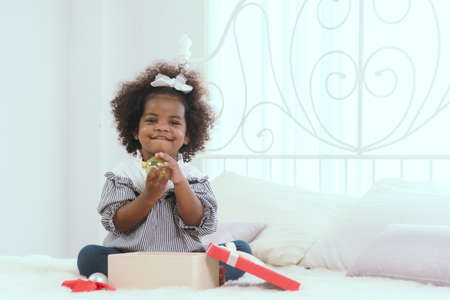 Black children are having fun playing with toys and gifts.の写真素材