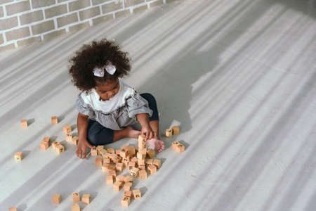 Young black girl is having fun playing and learning to strengthen her cognitive skills at home.の写真素材