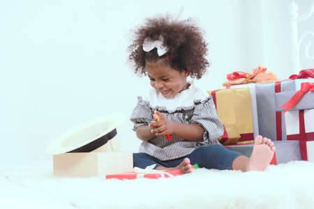 Black children are having fun playing with toys and gifts.の写真素材