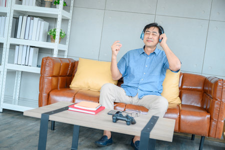 A retired elderly man spends his vacation at home listening to music. relax, restの写真素材