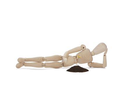 wooden man lying with small treeの写真素材