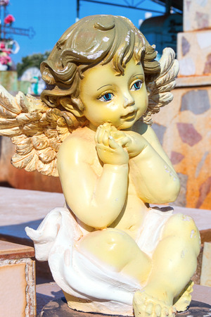 Vertical photo in color about a cherub in graveyardの写真素材