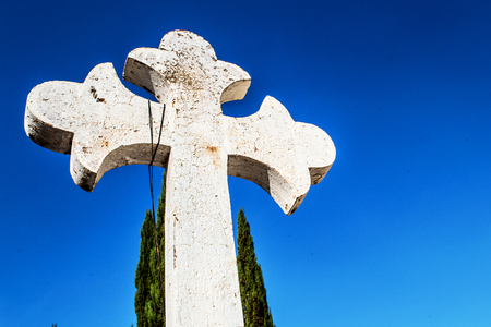 Horizontal photo in color of white christian cross and blue skyの写真素材