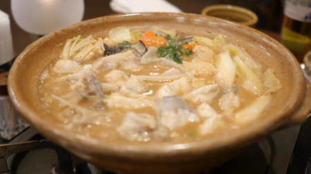Japanese soup with fish and vegetables in a bowl on the table.の写真素材
