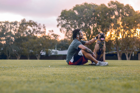 Man sitting with a dogのeditorial素材