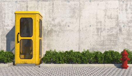 Single old yellow phone booth in retro style on the footpath in the urban exterior opposite the facade of the concrete wall and red fire hydrant. 3D rendering.の写真素材