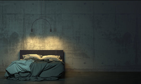 Dark room in the twilight with empty bed standing on the floor in front of the concrete wall. Gloomy...