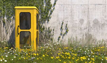 Single old yellow phone booth in retro style in an abandoned place with grass, overgrown with weeds and wildflowers on a summer sunny day. 3D rendering.の写真素材