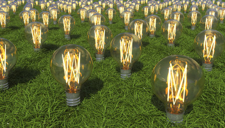 Glowing light bulb grow out of grass covered ground. Alternative renewable energy source. Production...