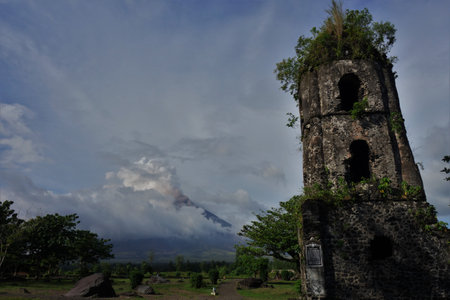 Church ruin in front of a cloud covered Mt Mayonの写真素材
