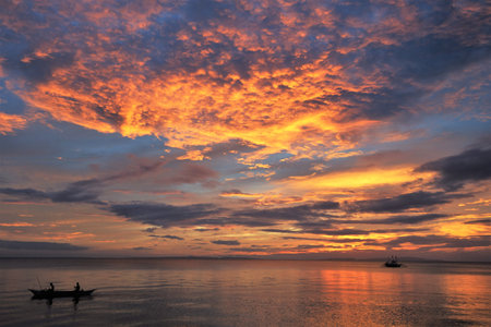 Amazing colours in the sky as the sun sets over southern Luzon, Philippinesの写真素材