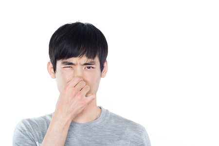 Portrait of a young man in a white Studioの写真素材