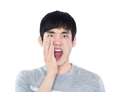 Portrait of young man with shocked facial expression, isolatedの写真素材