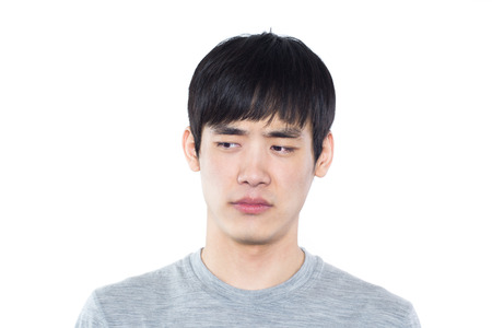 Portrait of a young man in a white Studioの写真素材