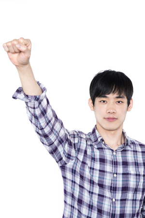 Successful young man celebrating against a white backgroundの写真素材