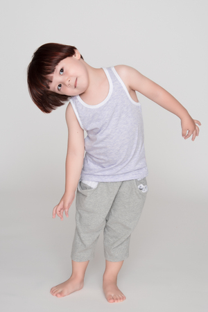 little asian boy on gray backgroundの写真素材