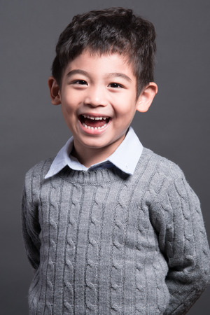 little asian boy on gray backgroundの写真素材