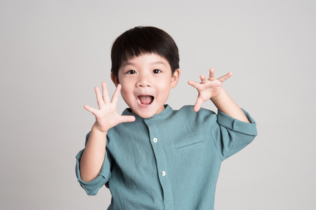 little asian boy on gray backgroundの写真素材