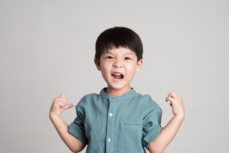 little asian boy on gray backgroundの写真素材