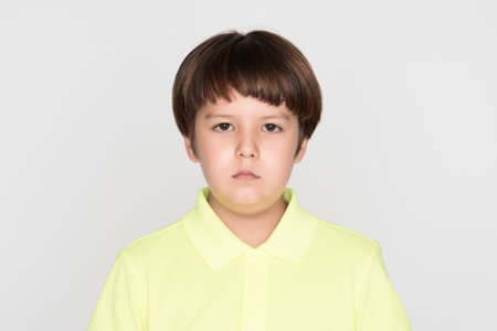 little asian boy on gray background