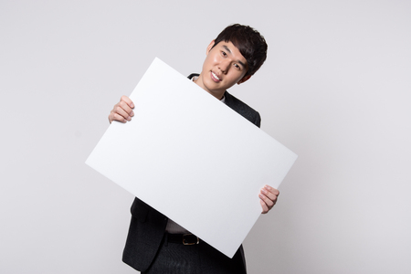 portrait of a smart young asian businessman gray backgroundの写真素材
