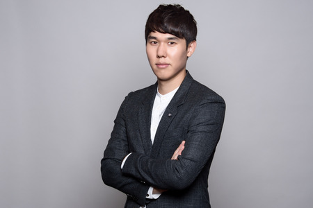 portrait of a smart young asian businessman gray backgroundの写真素材