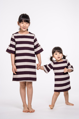 Studio shot of Asian sister - isolatedの写真素材