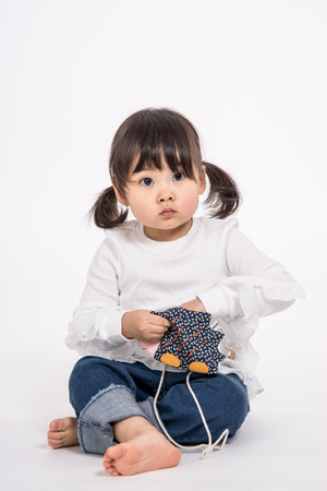 Studio portrait shot of 3-year-old Asian baby - isolatedの写真素材