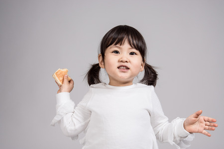 Studio portrait shot of 3-year-old Asian baby - isolatedの写真素材