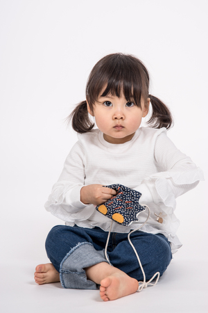 Studio portrait shot of 3-year-old Asian baby - isolatedの写真素材