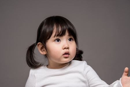 Studio portrait shot of 3-year-old Asian baby - isolatedの写真素材