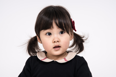 Studio portrait shot of 3-year-old Asian baby - isolatedの写真素材