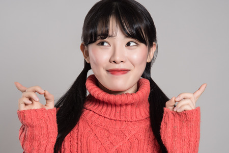 Studio portrait of twenties Asian woman expressing happiness in various actionsの写真素材