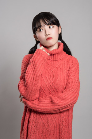 Studio portrait of 20 Asian women in deep troubleの写真素材