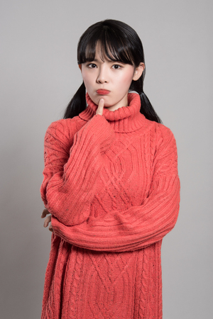 Studio portrait of 20 Asian women in deep troubleの写真素材