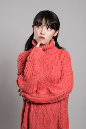 Studio portrait of 20 Asian women in deep troubleの写真素材