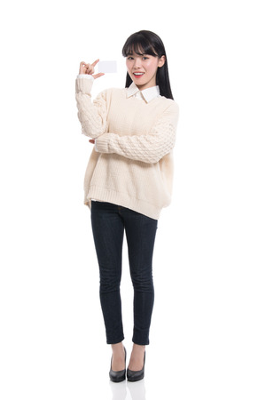 Studio portrait of twenties Asian woman happily having a cardの写真素材
