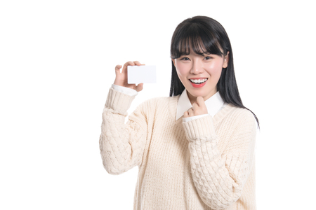 Studio portrait of twenties Asian woman happily having a cardの写真素材