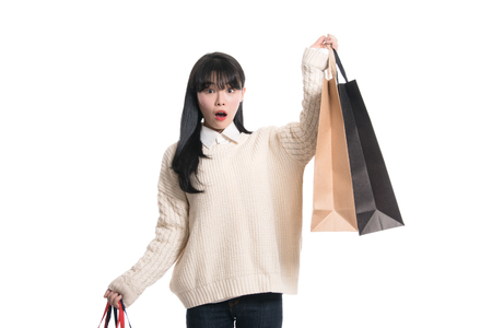 Studio portrait of twenties Asian woman happily shoppingの写真素材