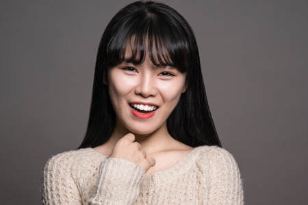 Studio portrait of a happy twenties Asian womanの写真素材