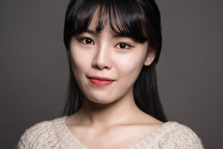 Studio portrait of a happy twenties Asian womanの写真素材