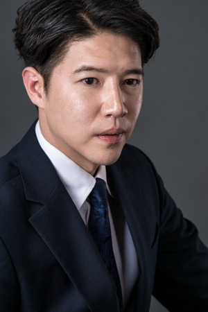 East Asian businessman shooting studio portrait photoの写真素材