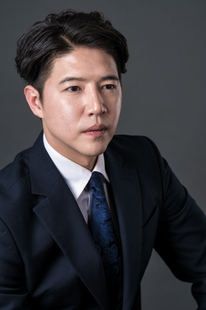 East Asian businessman shooting studio portrait photoの写真素材
