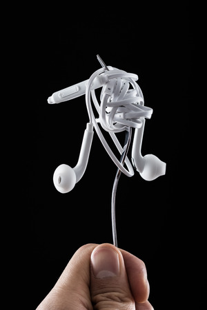 Earphone on fork on black backgroundの写真素材